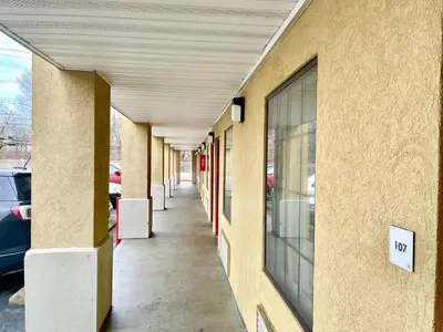 a hallway of a building with cars parked at Red Carpet Inn Philadelphia Airport in Lester