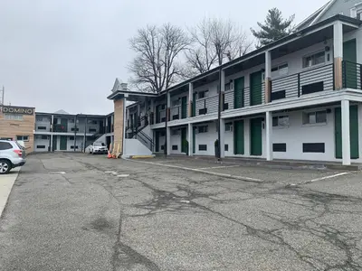 an empty parking lot in front of a building at Domino Inn in North Bergen