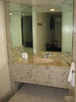a bathroom with two sinks and a large mirror at Domino Inn in North Bergen