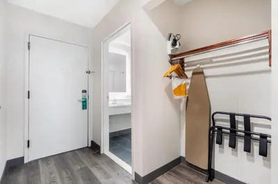 a bathroom with a closet and a sink at Quality Inn & Suites NJ State Capital Area in Morrisville