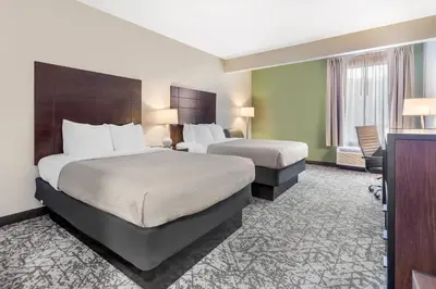 a hotel room with two beds and a television at Quality Inn & Suites NJ State Capital Area in Morrisville