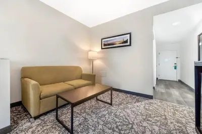 a living room with a couch and a table at Quality Inn & Suites NJ State Capital Area in Morrisville