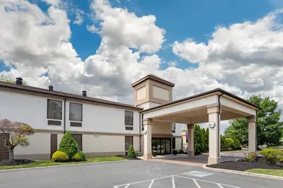 a large white building with a parking lot at Quality Inn & Suites NJ State Capital Area in Morrisville