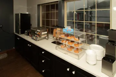 a counter top with a bunch of donuts on it at Scottish Inns & Suites - North Hershey in Harrisburg