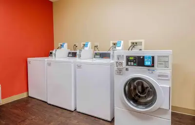 a row of washing machines and a washer and dryer at Extended Stay America Suites - Elizabeth - Newark Airport in Elizabeth