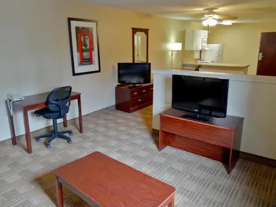 a hotel room with a desk and a television and a chair at Extended Stay America Suites - Elizabeth - Newark Airport in Elizabeth