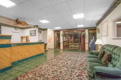 a lobby with a waiting room with a couch at Super 8 by Wyndham Carlisle North in Carlisle