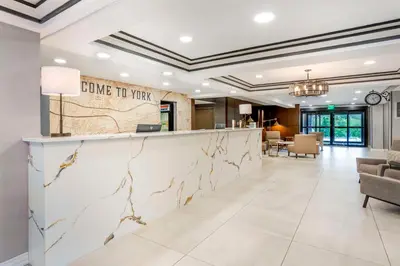 a lobby of a hotel with a reception counter at Best Western Plus Heritage Rail Inn & Suites in York
