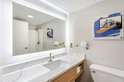 a bathroom with a sink and a mirror at Best Western Plus Heritage Rail Inn & Suites in York