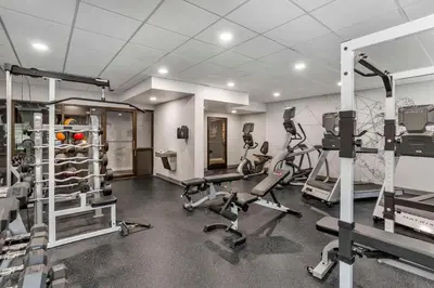 a gym with treadmills and machines in a room at Best Western Plus Heritage Rail Inn & Suites in York