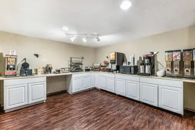 a large kitchen with white counter tops and appliances at Red Carpet Inn & Suites in Hazleton