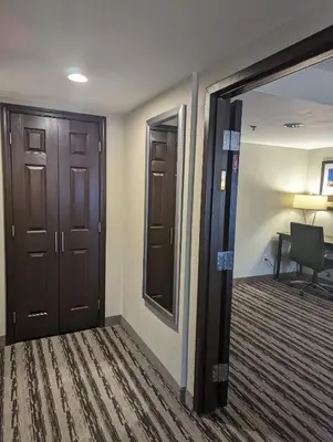a hallway with two doors and a desk in a room at Holiday Inn Harrisburg East by IHG in Middletown