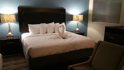 a hotel room with a large bed with two lamps at Holiday Inn Harrisburg East by IHG in Middletown