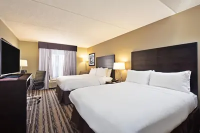 a hotel room with two beds and a flat screen tv at Holiday Inn Harrisburg East by IHG in Middletown