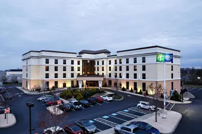 a rendering of a hotel with cars parked in a parking lot at Holiday Inn Express & Suites Harrisburg West in Mechanicsburg