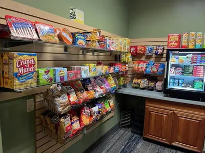 a store aisle with a display of chips and other snacks at Holiday Inn Express & Suites Harrisburg West in Mechanicsburg