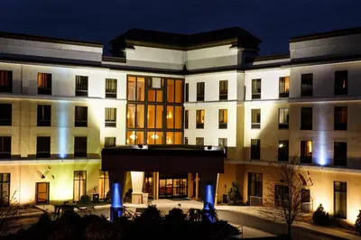 a large white building at night with lights at Holiday Inn Express & Suites Harrisburg West in Mechanicsburg