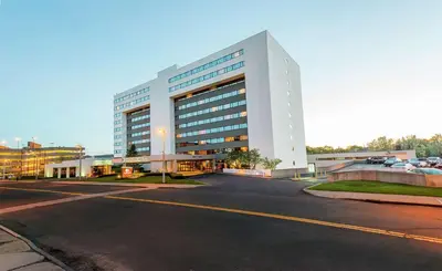 a large white building on the side of a street at DoubleTree by Hilton Binghamton in Binghamton