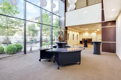an office lobby with a table and large windows at DoubleTree by Hilton Binghamton in Binghamton