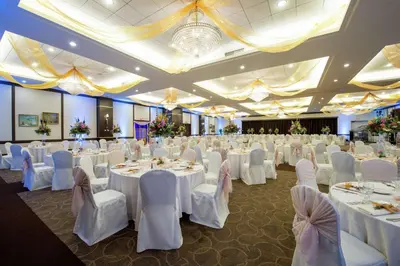a banquet hall with white tables and chairs at DoubleTree by Hilton Binghamton in Binghamton