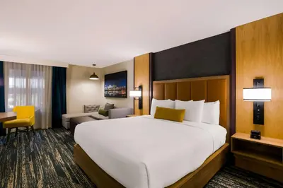 a large white bed in a hotel room at Best Western Premier the Central Hotel & Conference Center in Harrisburg