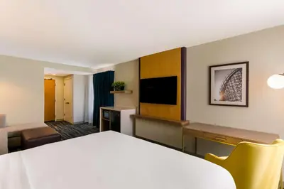 a hotel room with a bed and a living room at Best Western Premier the Central Hotel & Conference Center in Harrisburg
