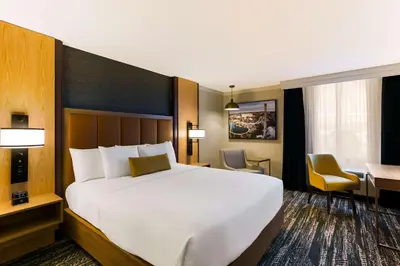 a hotel room with a large bed and a desk at Best Western Premier the Central Hotel & Conference Center in Harrisburg
