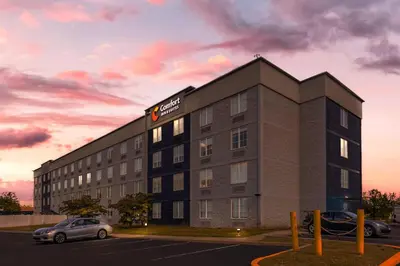 a building with a car parked in a parking lot at Comfort Inn & Suites Pottstown Eastern Gateway in Pottstown