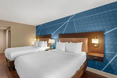 two beds in a hotel room with blue walls at Comfort Inn & Suites Pottstown Eastern Gateway in Pottstown