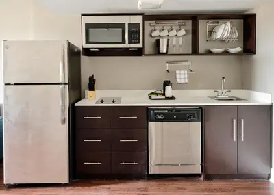 a kitchen with a stainless steel refrigerator and microwave at Comfort Inn & Suites Pottstown Eastern Gateway in Pottstown