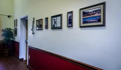 a hallway with pictures on the wall at Cocoa Country Inn Hershey in Hershey