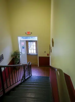 a staircase with an exit sign in a building at Cocoa Country Inn Hershey in Hershey