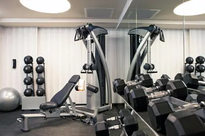 a gym with several tread machines and weights at Hotel 48LEX New York in New York