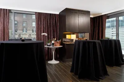 two tables with black table cloths in a room at Hotel 48LEX New York in New York
