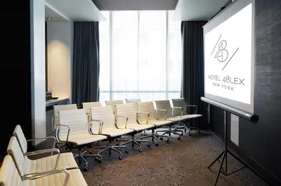 a lecture room with chairs and a projection screen at Hotel 48LEX New York in New York