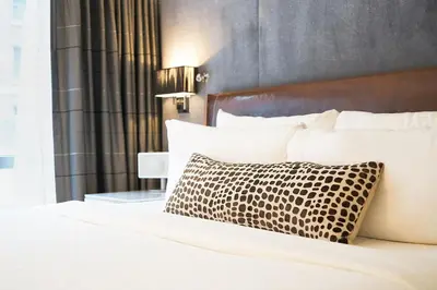 a bed with a brown and white pillow on it at Hotel 48LEX New York in New York