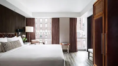 a hotel room with a bed and a large window at Hotel 48LEX New York in New York