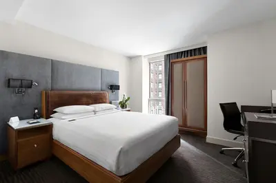 a hotel room with a bed and a desk and a computer at Hotel 48LEX New York in New York