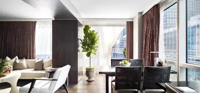 a living room with a couch and a table and chairs at Hotel 48LEX New York in New York
