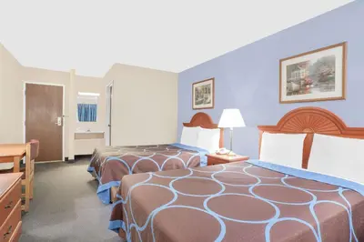 a hotel room with two beds and a bathroom at Super 8 by Wyndham Middletown in Middletown