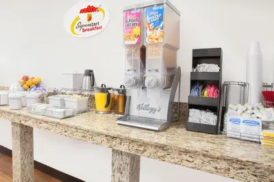 a counter with some food and drinks on it at Super 8 by Wyndham Middletown in Middletown