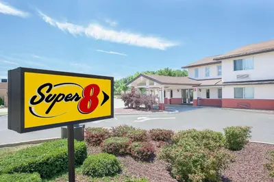 a super sign in front of a building at Super 8 by Wyndham Middletown in Middletown