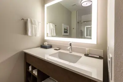 a bathroom with a sink and a mirror at La Quinta Inn & Suites by Wyndham Middletown-Goshen in Middletown