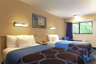 a hotel room with two beds and a window at Days Inn by Wyndham Monmouth Junction-S Brunswick-Princeton in Monmouth Junction