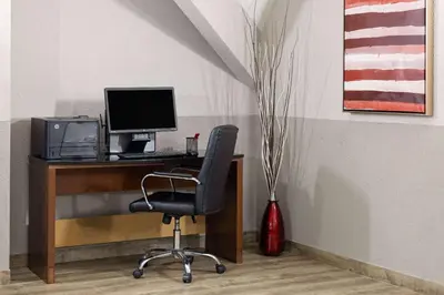 an office with a desk with a computer and a chair at Ramada by Wyndham Parsippany in Parsippany