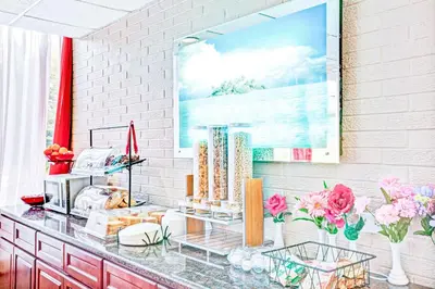 a counter with vases and flowers in a room at Ramada by Wyndham Rockaway in Rockaway