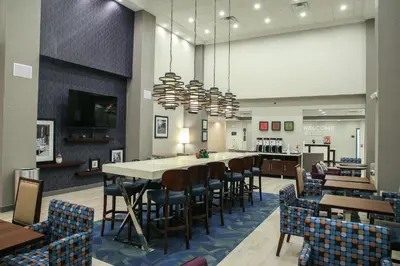 a restaurant with a long table and chairs at Hampton Inn & Suites Mount Laurel/Moorestown in Mount Laurel