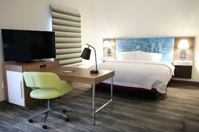 a hotel room with a bed and a desk with a television at Hampton Inn & Suites Mount Laurel/Moorestown in Mount Laurel