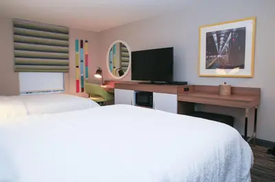 a hotel room with two beds and a desk with a television at Hampton Inn & Suites Mount Laurel/Moorestown in Mount Laurel