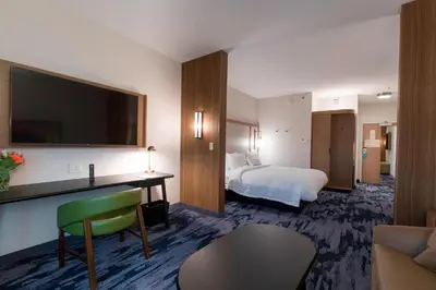 a hotel room with a bed and a desk with a television at Fairfield Inn & Suites by Marriott Philadelphia Valley Forge/Great Valley in Berwyn